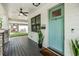 Inviting front porch with light teal door and lush greenery at 1210 E Mohawk Ave, Tampa, FL 33604