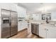 Modern kitchen with stainless steel appliances and white shaker cabinets at 1210 E Mohawk Ave, Tampa, FL 33604