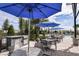 Outdoor kitchen with grills and seating under blue umbrellas at 12408 52Nd E St, Parrish, FL 34219