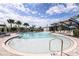 Community pool with a shallow area and plenty of lounge chairs at 12408 52Nd E St, Parrish, FL 34219