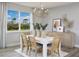 Bright dining room with large windows and a modern chandelier at 12436 52Nd E St, Parrish, FL 34219