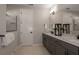 Modern bathroom featuring a double vanity with granite countertops, sleek fixtures, and a glass-enclosed shower at 12656 Glenn Creek Dr, Riverview, FL 33569