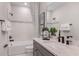 Clean bathroom featuring a granite countertop vanity, framed mirror and a shower-tub combo with stylish tile design at 12656 Glenn Creek Dr, Riverview, FL 33569