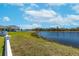 Large backyard with a lake view and grassy area at 12712 Mangrove Forest Dr, Riverview, FL 33579