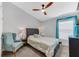 Comfortable bedroom with a queen bed, teal chair, and window with blinds at 12712 Mangrove Forest Dr, Riverview, FL 33579