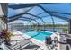 Screened pool and spa with lake view and lounge chairs at 12712 Mangrove Forest Dr, Riverview, FL 33579