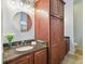 Bathroom boasts dark wood cabinets and granite counters at 1330 Monte Lake Dr, Valrico, FL 33596