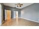 Bright bedroom featuring wood floors and a ceiling fan at 1330 Monte Lake Dr, Valrico, FL 33596