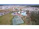 Aerial view of community with pool, tennis courts, and homes at 13455 Jamaica Plank Loop, Riverview, FL 33579