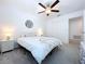 Bedroom with white bedding and ceiling fan at 13455 Jamaica Plank Loop, Riverview, FL 33579