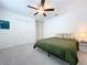 Bedroom with green bedding and ceiling fan at 13455 Jamaica Plank Loop, Riverview, FL 33579