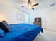 Bedroom with blue bedding and ceiling fan at 13455 Jamaica Plank Loop, Riverview, FL 33579