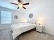 Bedroom with white bedding and ceiling fan at 13455 Jamaica Plank Loop, Riverview, FL 33579