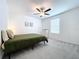 Bedroom with green bedding and ceiling fan at 13455 Jamaica Plank Loop, Riverview, FL 33579