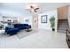 Open living space with blue sectional sofa and kitchen view at 13455 Jamaica Plank Loop, Riverview, FL 33579