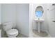 Clean, modern powder room with pedestal sink and toilet at 13455 Jamaica Plank Loop, Riverview, FL 33579