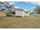 Side view of a charming white house with a covered porch at 1424 E Bougainvillea Ave, Tampa, FL 33612