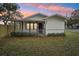 Charming white house with a front porch and landscaping at 1424 E Bougainvillea Ave, Tampa, FL 33612