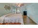 Spacious bedroom with light walls, ceiling fan, and wood-look flooring at 148 Gull Aire Blvd, Oldsmar, FL 34677