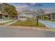 Front view of a white single story home with carport at 148 Gull Aire Blvd, Oldsmar, FL 34677