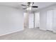 Bright bedroom with ceiling fan and neutral carpeting, plus a view of hallway at 1505 Chateaux De Ville Ct, Clearwater, FL 33764