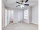 Bedroom with ceiling fan, window, and access to bathroom and closet at 1505 Chateaux De Ville Ct, Clearwater, FL 33764