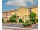 Tan and yellow townhomes with lush landscaping at 1505 Chateaux De Ville Ct, Clearwater, FL 33764