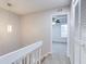 Upstairs hallway with white railing and view of bedroom at 1505 Chateaux De Ville Ct, Clearwater, FL 33764