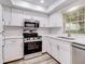 Modern kitchen featuring white cabinets and stainless steel appliances at 1505 Chateaux De Ville Ct, Clearwater, FL 33764