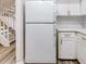 White refrigerator in a kitchen with white cabinets at 1505 Chateaux De Ville Ct, Clearwater, FL 33764