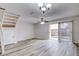 Spacious living room with wood-look floors and sliding doors to patio at 1505 Chateaux De Ville Ct, Clearwater, FL 33764