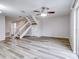 Living room with stairs, wood-look floors and ceiling fan at 1505 Chateaux De Ville Ct, Clearwater, FL 33764