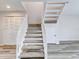 White stairs with gray carpeting leading to upper level at 1505 Chateaux De Ville Ct, Clearwater, FL 33764