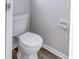 White toilet and wood-look flooring at 1505 Chateaux De Ville Ct, Clearwater, FL 33764