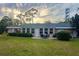 Serene backyard view, showcasing a patio and lush landscaping at 1510 Palmer Ct, Palm Harbor, FL 34685