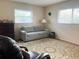 Spacious guest room with a sofa, armchair, and large windows at 1510 Palmer Ct, Palm Harbor, FL 34685