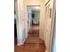 Bright hallway with hardwood floors, leading to other rooms and closets at 1510 Palmer Ct, Palm Harbor, FL 34685