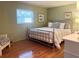 Main bedroom with hardwood floors, a king-size bed and access to a sitting area at 1510 Palmer Ct, Palm Harbor, FL 34685