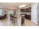 Kitchen with island, granite countertops and dark cabinets at 15737 High Bell Pl, Bradenton, FL 34212