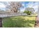 Spacious backyard with wooden fence and lush grass at 19106 Cellini Pl, Lutz, FL 33558