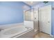 Clean bathroom with a large tub and a separate shower at 19106 Cellini Pl, Lutz, FL 33558