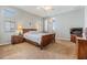 Spacious bedroom with a wooden sleigh bed and plenty of natural light at 19106 Cellini Pl, Lutz, FL 33558