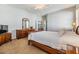 Main bedroom with wood furniture and neutral carpeting at 19106 Cellini Pl, Lutz, FL 33558