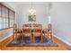 Dining room with hardwood floors, chandelier, and a wooden table at 19106 Cellini Pl, Lutz, FL 33558