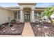 Landscaped front yard with walkway to the entrance of a house at 19106 Cellini Pl, Lutz, FL 33558