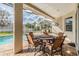 Relaxing covered patio area with table and chairs overlooking the refreshing pool at 19106 Cellini Pl, Lutz, FL 33558