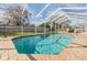 Inviting kidney-shaped swimming pool with a screened enclosure at 19106 Cellini Pl, Lutz, FL 33558