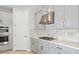 Modern kitchen with gray cabinets, stainless steel appliances, and white countertops at 1912 Longliner Loop, Wesley Chapel, FL 33543