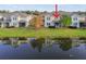 Townhome and lake view from the back of property with reflection at 1950 Marlington Way, Clearwater, FL 33763