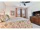 Main bedroom with floral bedding and ceiling fan at 1950 Marlington Way, Clearwater, FL 33763